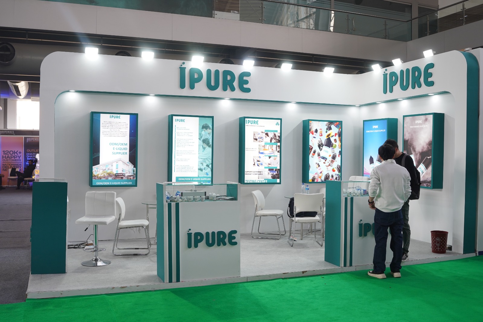 iPURE custom-built exhibition backdrop with curved architectural edges and teal branding