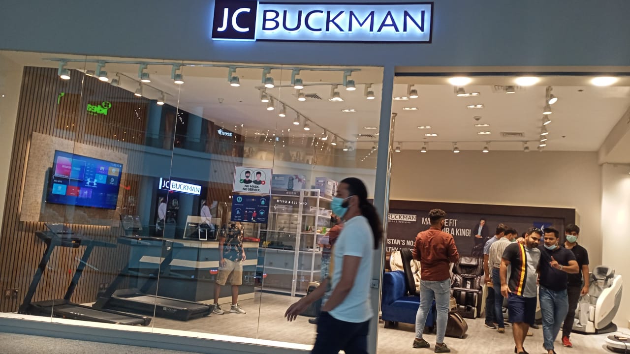 Shopping mall outlet design with JC Buckman backlit signage and glass storefront